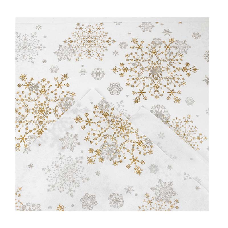 White tissue paper printed with gold and silver coloured snowflakes