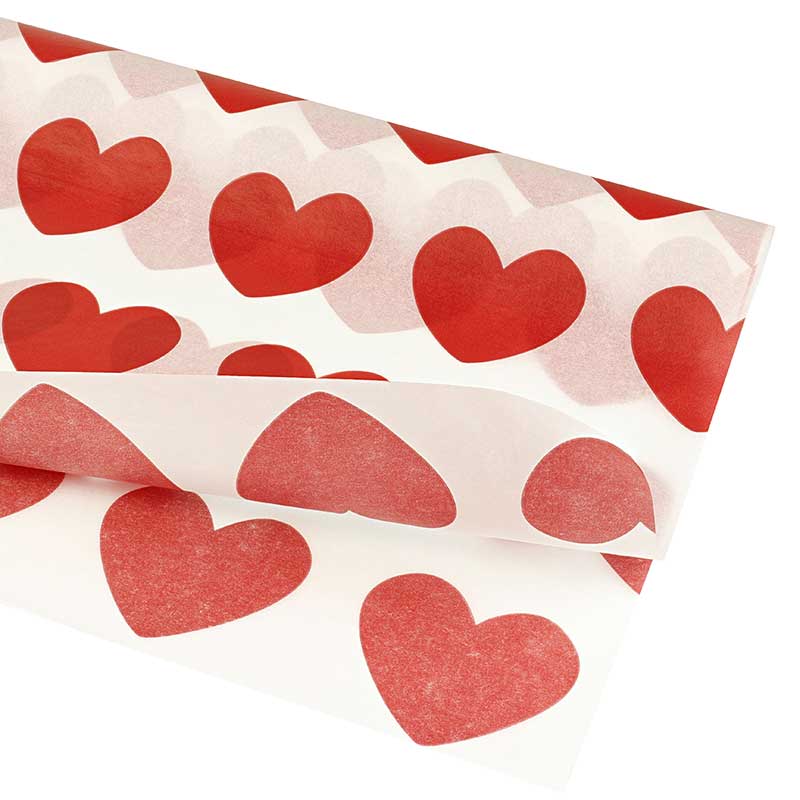 White tissue paper with red love heart motifs