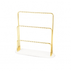 Gold-coloured metal 3 level display for 21 pairs of earrings with granite look white base