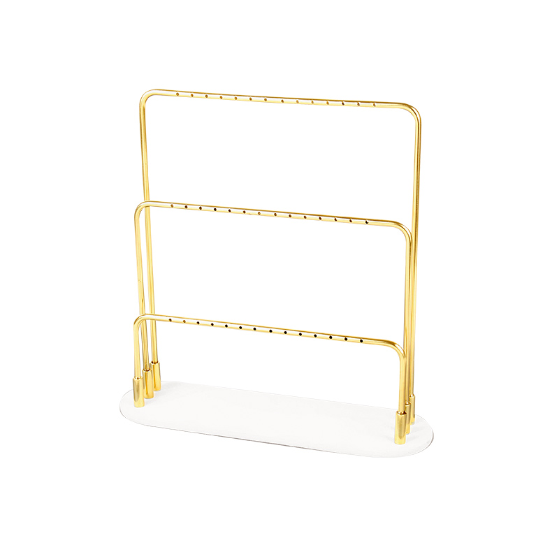 Gold-coloured metal 3 level display for 21 pairs of earrings with granite look white base